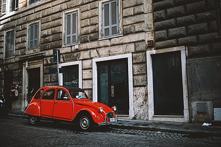red Volkswagen Beetle on gray road thumbnail