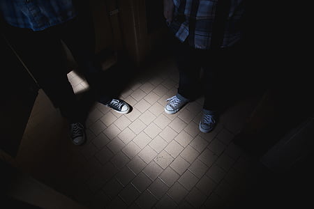 two person standing on gray tile flooring thumbnail