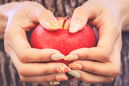 person holding apple with nail polish thumbnail