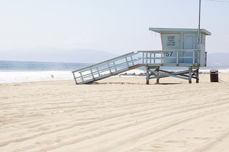 lifeguard tower near body of water during daytime thumbnail