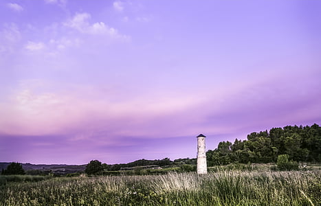 white lighthouse on green grass field thumbnail