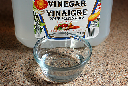 clear glass bowl beside vinegar bottle thumbnail