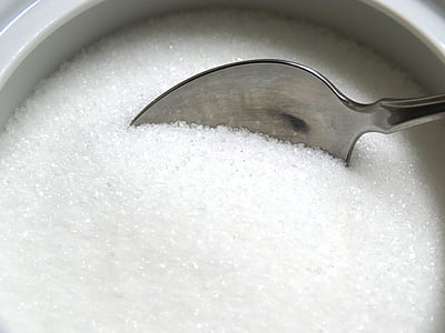stainless steel spoon scooping sugar thumbnail