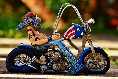 selective focus photography of man riding chopper motorcycle figurine thumbnail