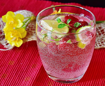 almost full clear drinking glass on red surface thumbnail