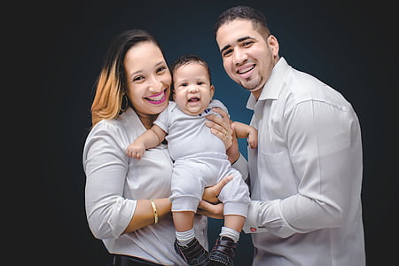 man wearing dress shirt standing beside woman holding baby thumbnail