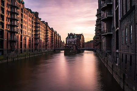 body of water between of brown concrete building thumbnail