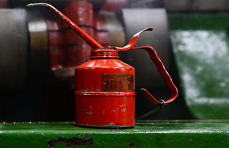 red oil can on green surface thumbnail