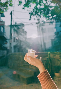 Person Holding Clear Glass Jar thumbnail
