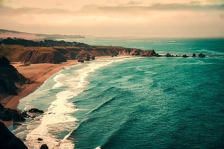 aerial view photography of beach under cloudy skies thumbnail