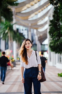 Woman Wearing White Dress Shirt and Blue Pants thumbnail
