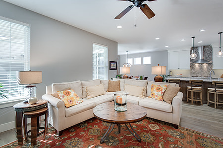 white leather corner sofa on area rug inside house thumbnail