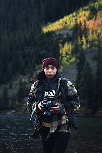 woman holding DSLR camera thumbnail