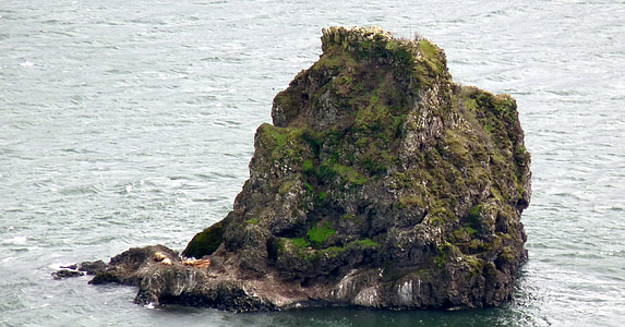 green and gray rock formation on body of water thumbnail