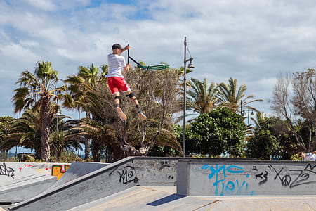 Man Doing Kick Scooter Aerial Trick on Park thumbnail