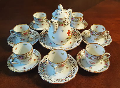 white-and-pink floral tea set on brown wooden surface thumbnail