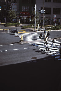 person walking on pedestrian lane near buildings during daytime thumbnail