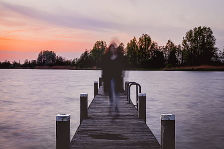 woman walking on brown dock thumbnail
