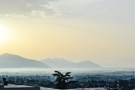 selective focus photography of mountain under white clouds thumbnail