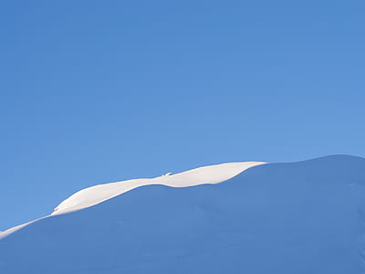 snow dune under blue sky at daytime thumbnail