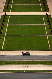 man standing in front of black car thumbnail