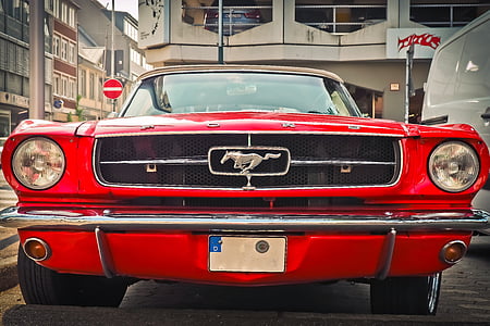 red Ford Mustang Fastback parked on gray road thumbnail