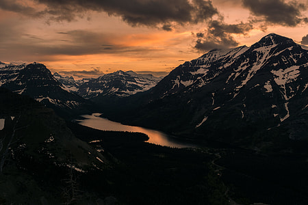 black and white mountain with body of water during golden hour thumbnail