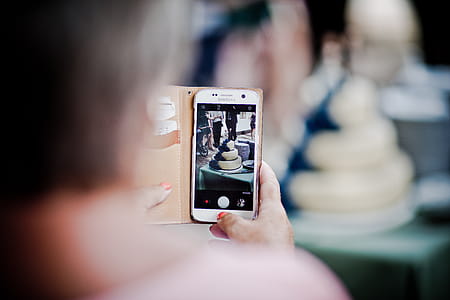 Person Holding Samsung Galaxy S7 Displaying 3-tier Cake thumbnail