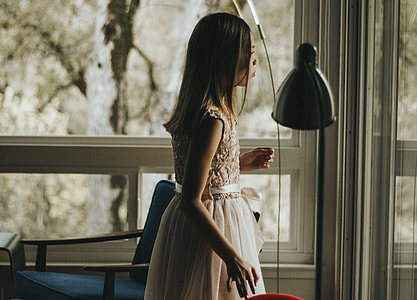 woman standing near glass window thumbnail