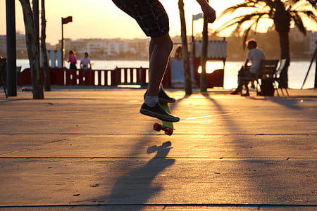person playing skateboard near river thumbnail