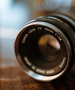 shallow photo of black Canon DSLR camera lens thumbnail