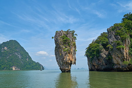 brown stone rock in the middle of body of water thumbnail