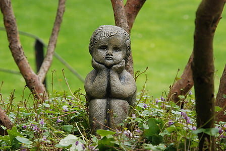 girl statue on grass field thumbnail