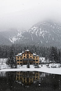 brown house surrounded by house near mountain during daytime thumbnail