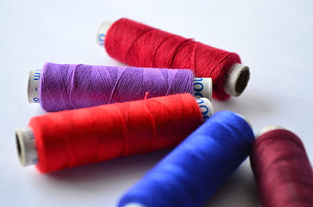 selective photo of thread spools thumbnail
