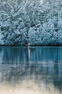 white and black barge cruising on body of water thumbnail