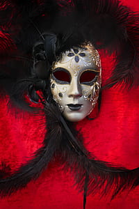 gray and black masquerade mask on red surface thumbnail