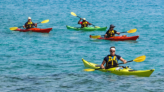 four person riding kayak on body of water thumbnail