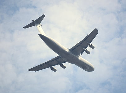 low-angle photography of white airplane under clear blue sky thumbnail