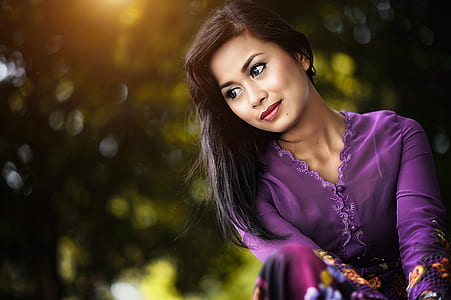 selective focus photography of woman in purple v-neck long-sleeved dress thumbnail