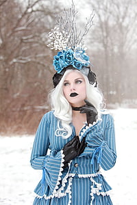 woman wearing blue and white striped attire and floral headdress thumbnail