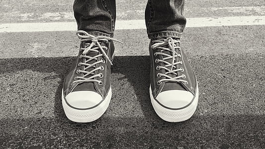 grayscale photo of person wearing low-top shoes thumbnail