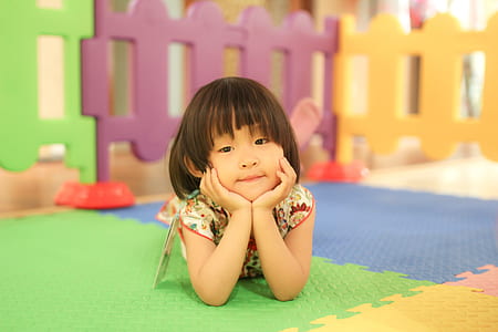 girl resting her face on jigsaw mat thumbnail