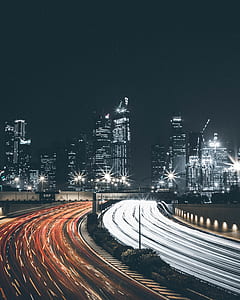 time-lapse photo of road with vehicles and high-rise buildings thumbnail