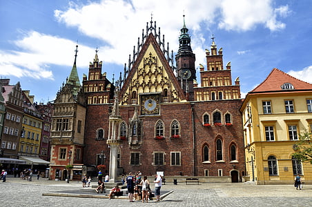 people walking near brown concrete cathedral during daytime thumbnail