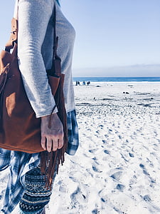 person wearing gray sweater on gray sand thumbnail