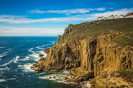 photo of houses near cliff and body of water thumbnail