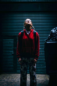 woman looking at white light above her thumbnail