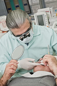 dentist holding man teeth thumbnail