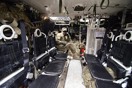 Man in Soldier Suit Sitting in Black Leather Seat thumbnail